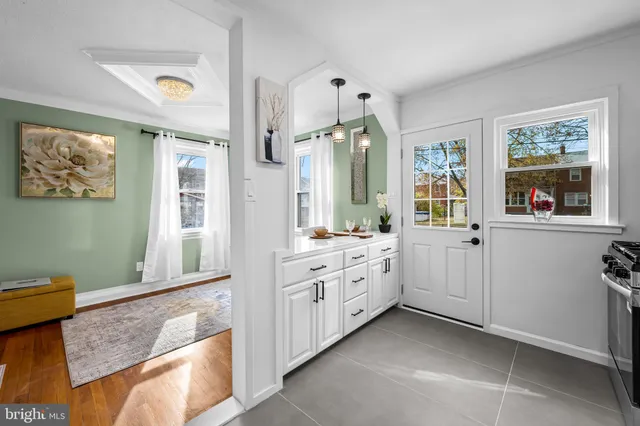 a spacious bathroom with a granite countertop sink mirror and a bathtub