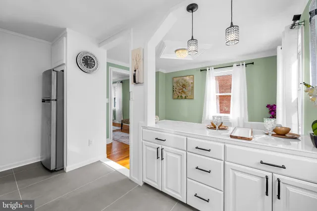 a spacious bathroom with a granite countertop sink a mirror and a shower