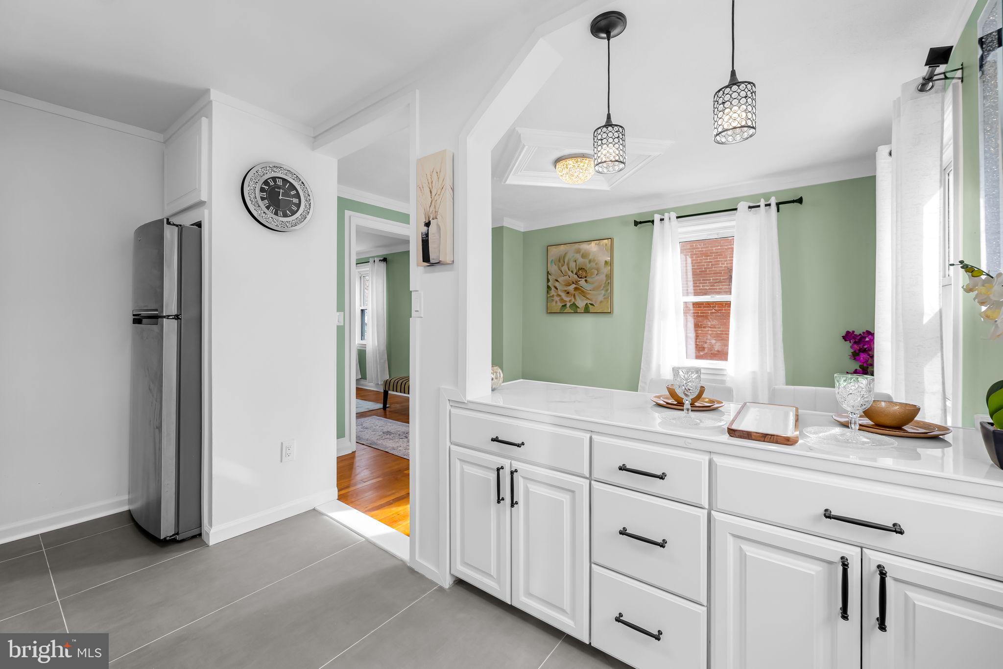 66 Stemmers Run Road Baltimore, MD 21221 - Photo 13 of 24 a spacious bathroom with a granite countertop sink a mirror and a shower