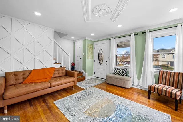 a living room with furniture rug and wooden floor