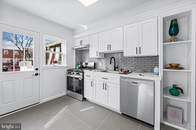 a kitchen with white cabinets and white appliances