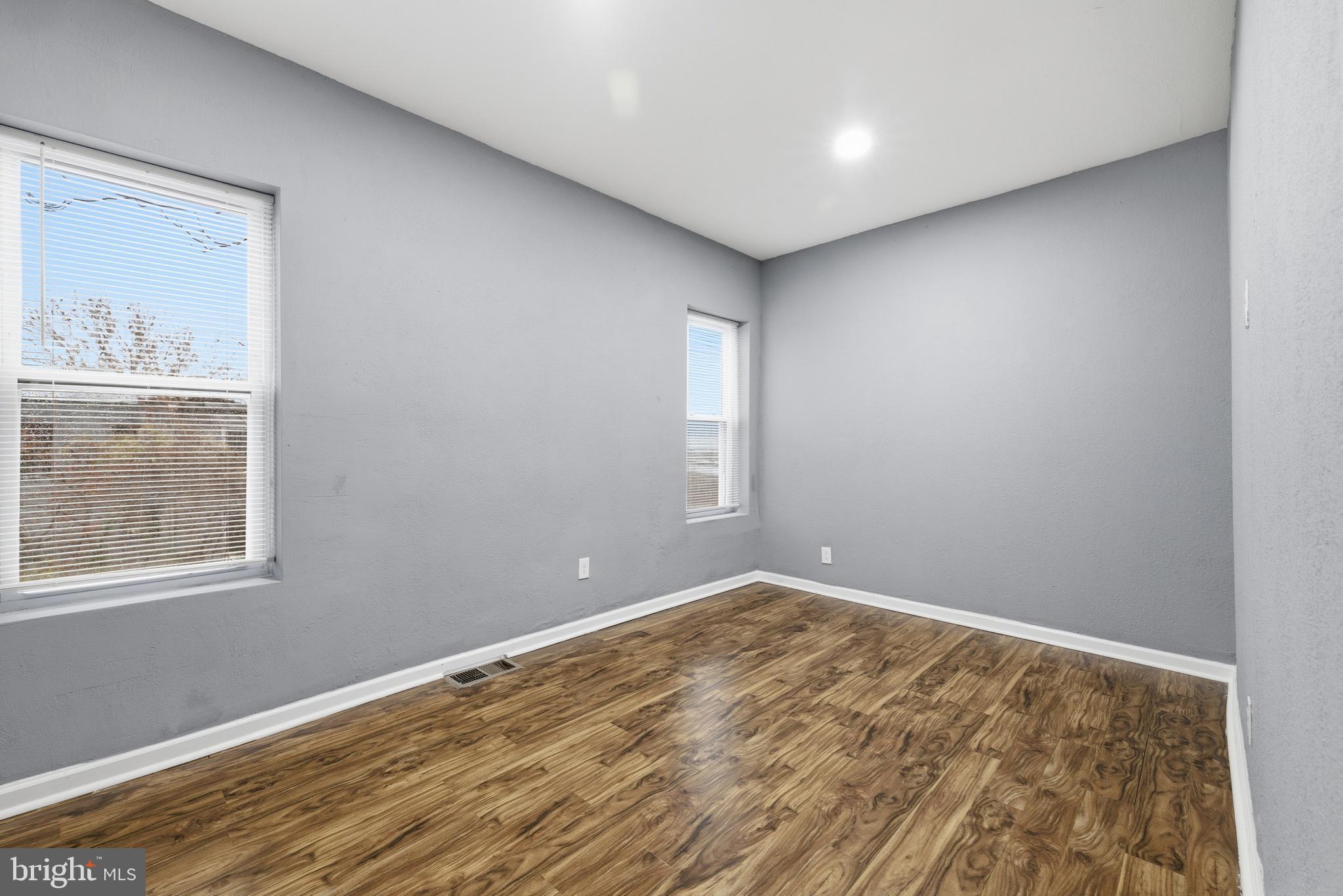 16 South Payson Street Baltimore, MD 21223 - Photo 11 of 16 a view of an empty room with wooden floor and a window