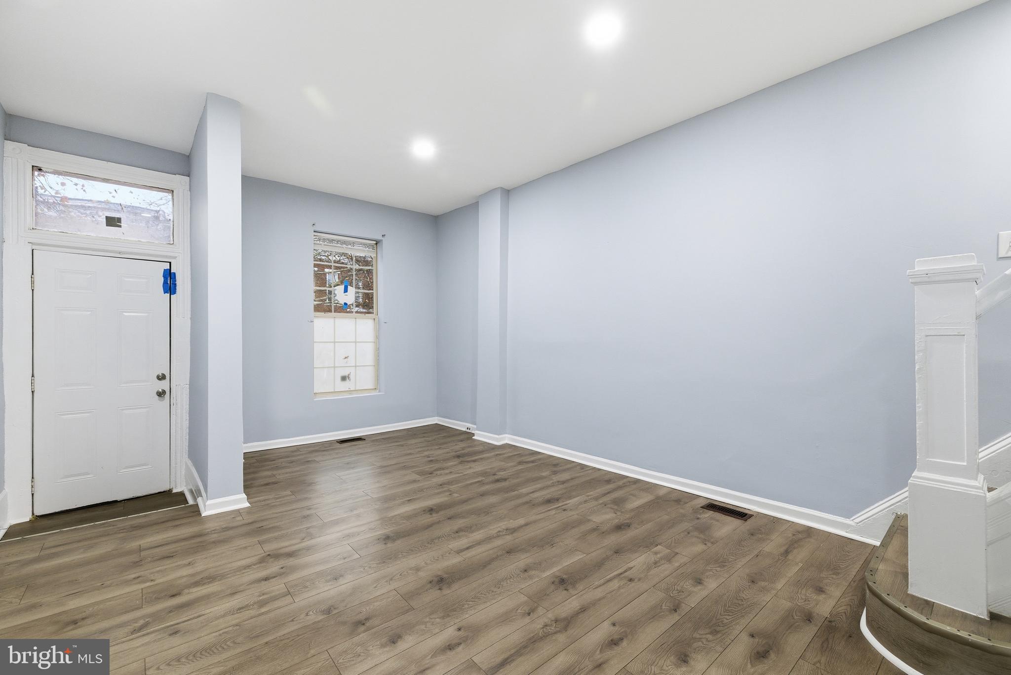 16 South Payson Street Baltimore, MD 21223 - Photo 3 of 16 a view of an empty room with wooden floor and a window