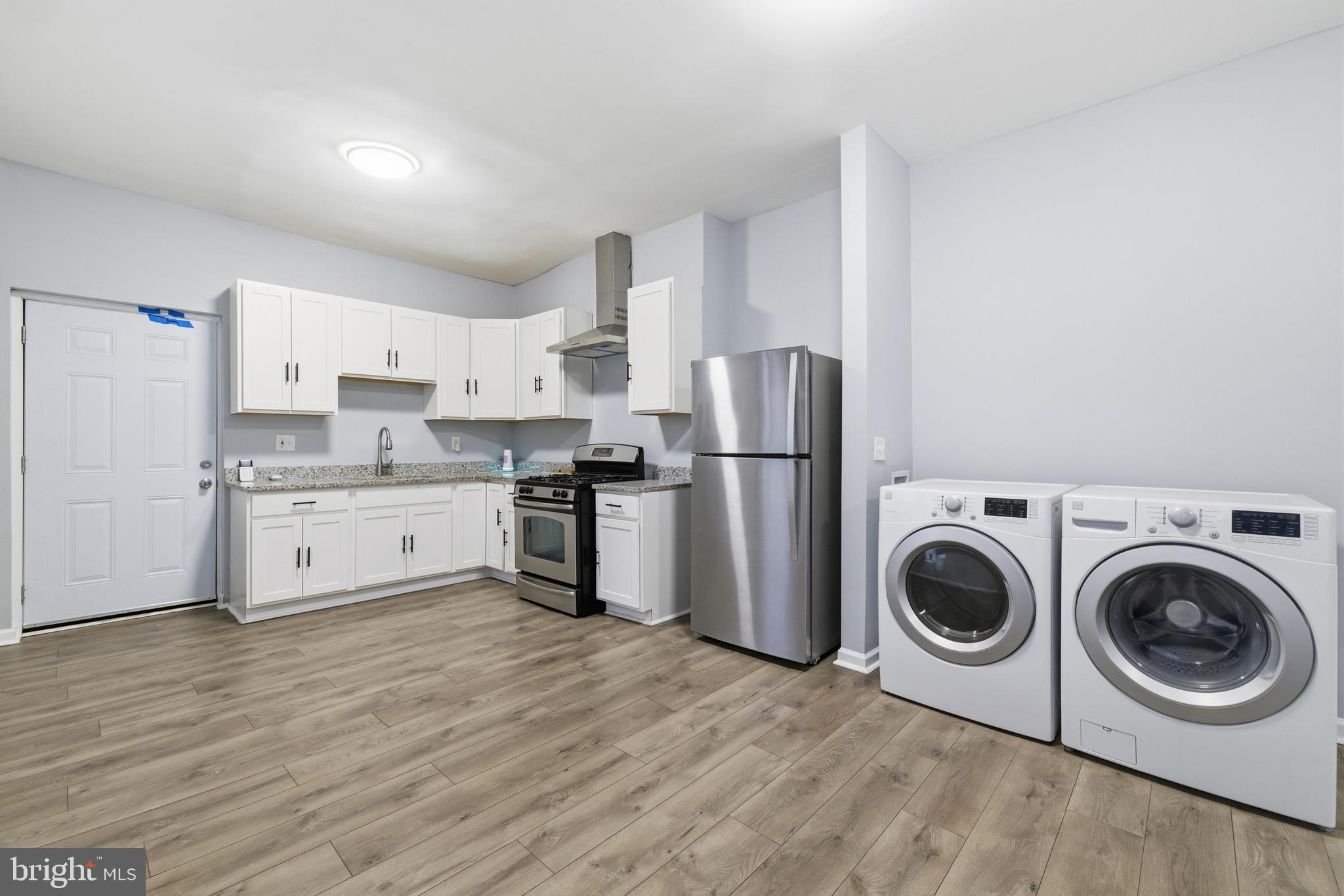 16 South Payson Street Baltimore, MD 21223 - Photo 6 of 16 a kitchen with a refrigerator sink and cabinets