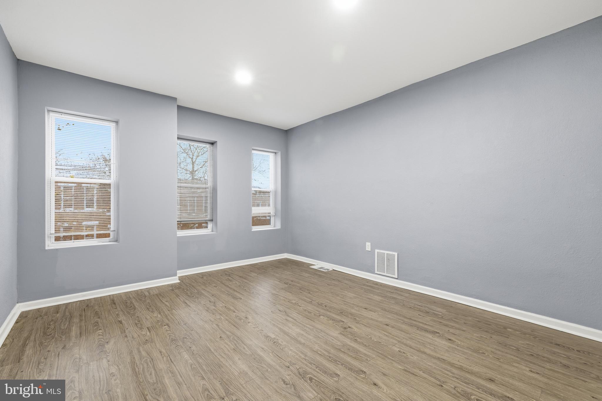 16 South Payson Street Baltimore, MD 21223 - Photo 9 of 16 a view of empty room with wooden floor and fan