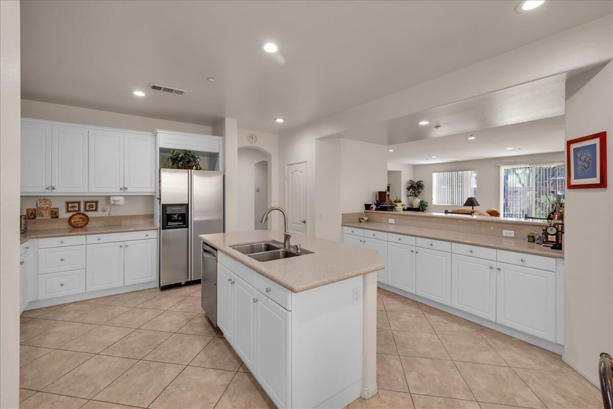 3467 Savanna Way Palm Springs, CA 92262 - Photo 12 of 49 a kitchen with stainless steel appliances granite countertop a sink and cabinets