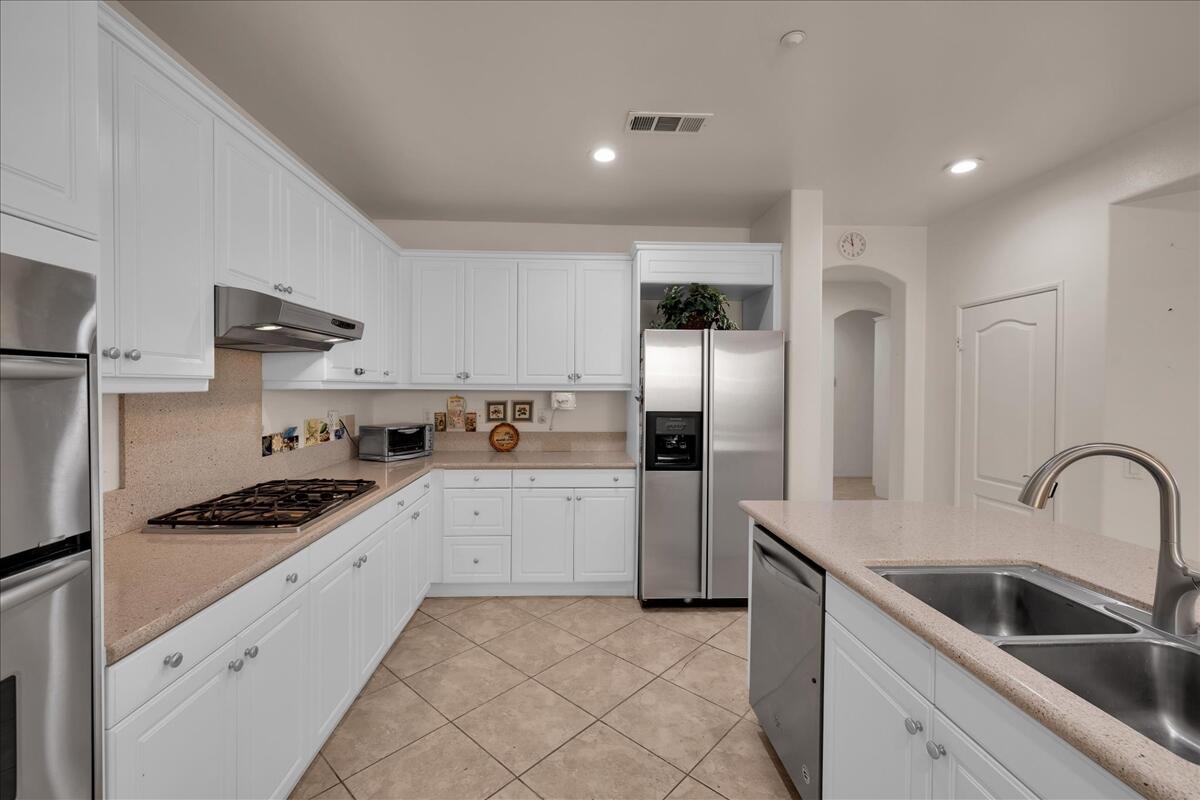3467 Savanna Way Palm Springs, CA 92262 - Photo 13 of 49 a kitchen with granite countertop a sink stainless steel appliances and cabinets