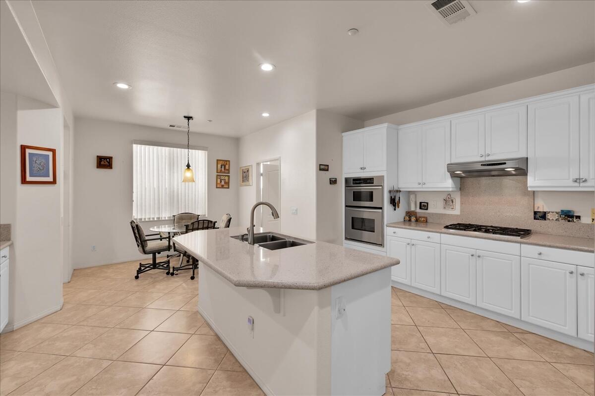 3467 Savanna Way Palm Springs, CA 92262 - Photo 15 of 49 a kitchen with stainless steel appliances granite countertop a sink and a refrigerator