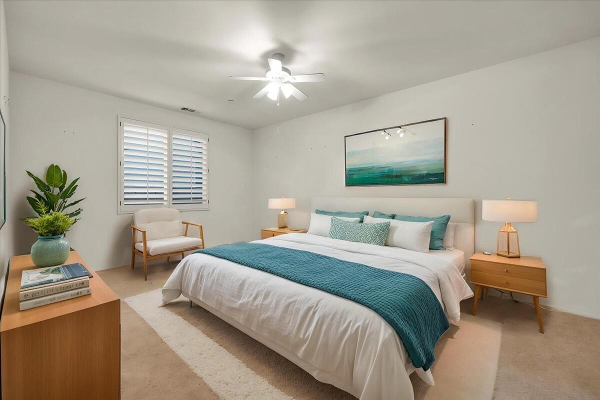 3467 Savanna Way Palm Springs, CA 92262 - Photo 25 of 49 a bedroom with a large bed and a chandelier