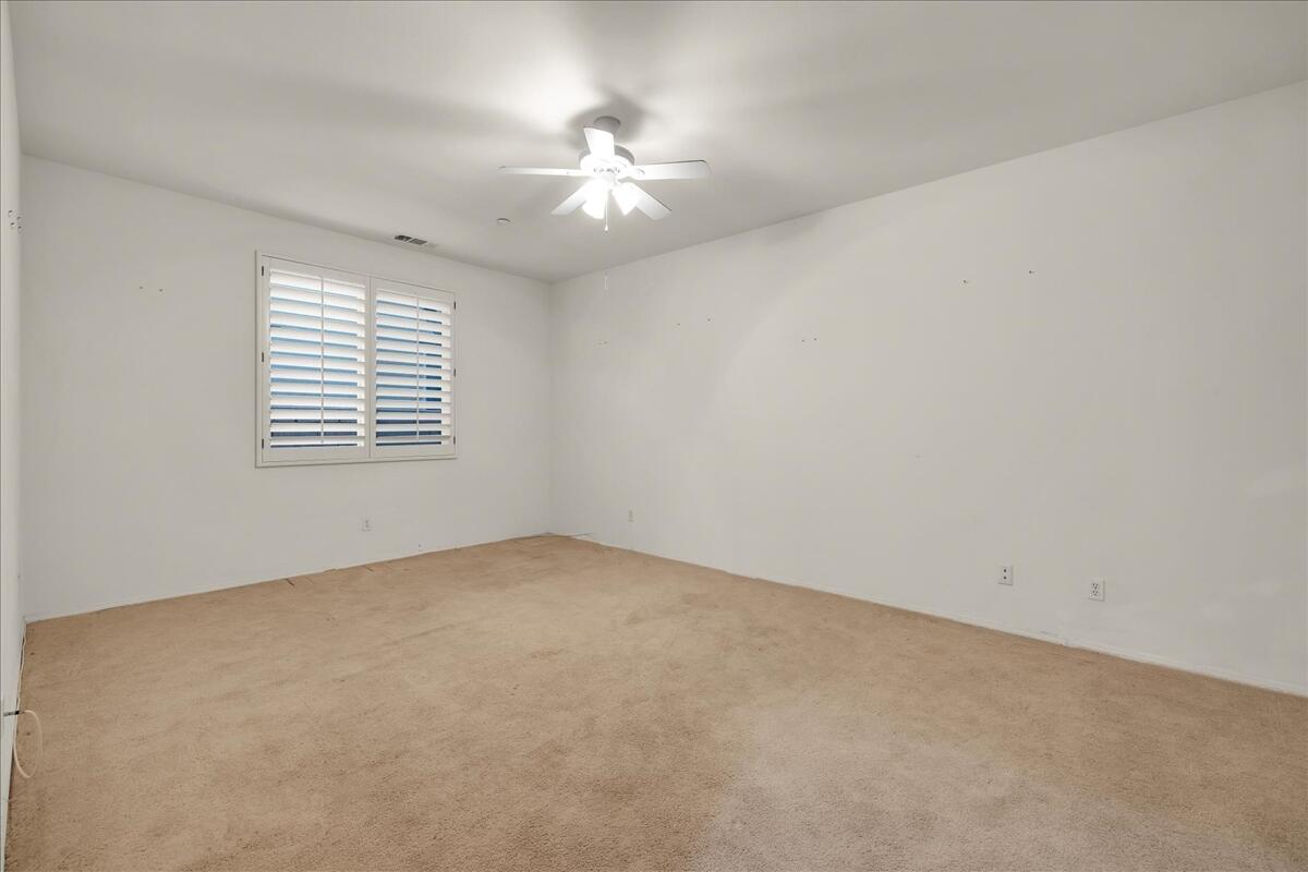 3467 Savanna Way Palm Springs, CA 92262 - Photo 27 of 49 an empty room with a chandelier fan and windows