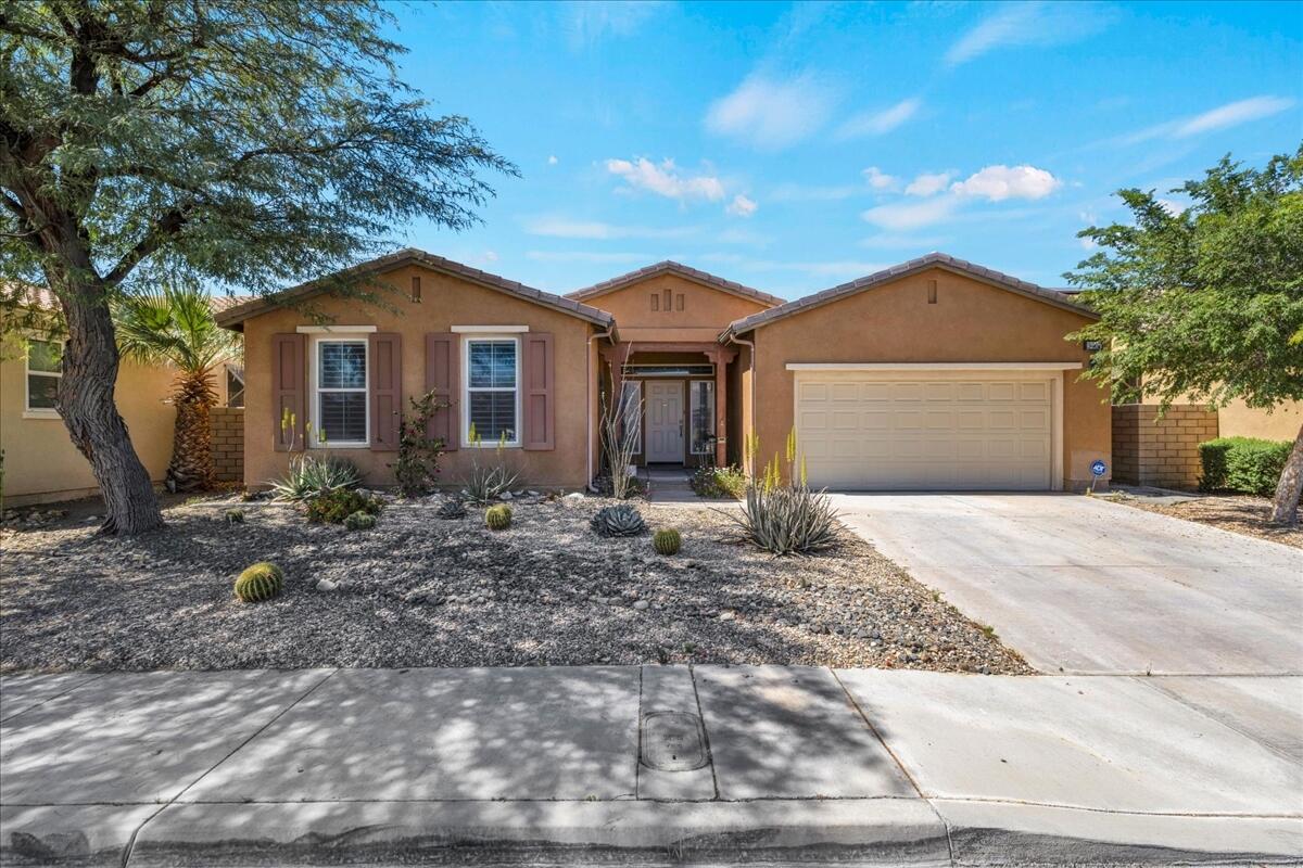 3467 Savanna Way Palm Springs, CA 92262 - Photo 29 of 49 a front view of a house with a garden