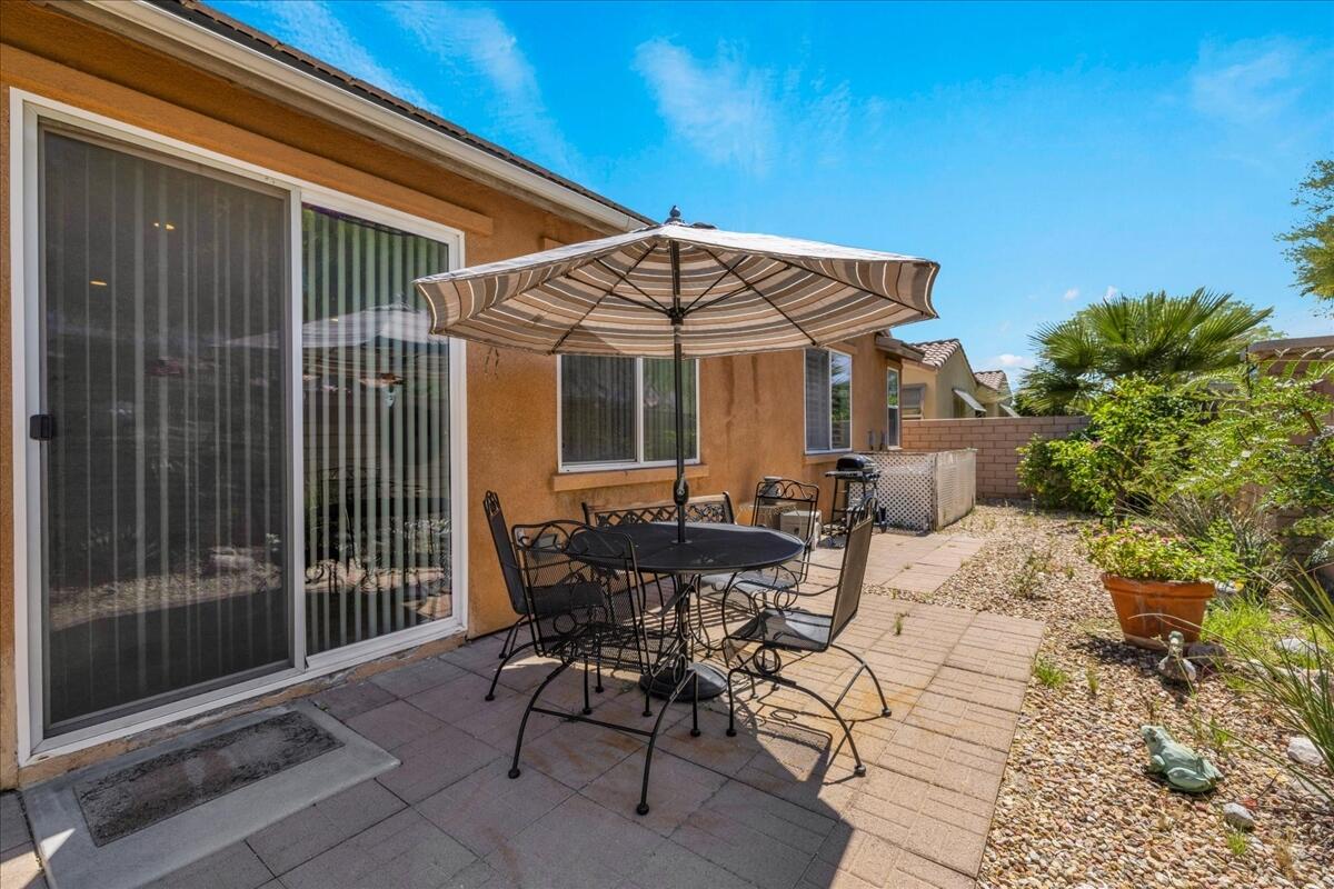 3467 Savanna Way Palm Springs, CA 92262 - Photo 32 of 49 a view of a patio with table and chairs and potted plants