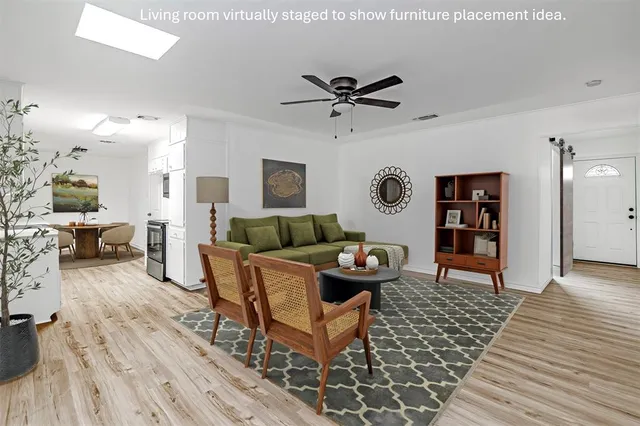 a living room with furniture and wooden floor