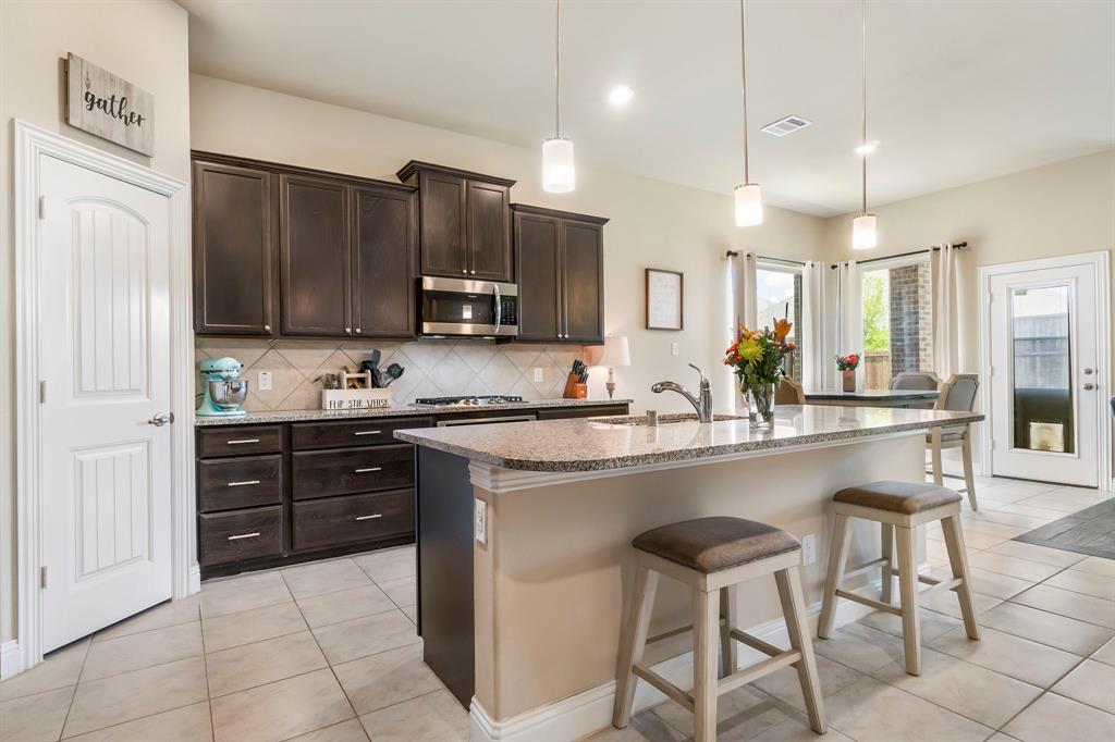 3610 Bastrop Street Melissa, TX 75454 - Photo 2 of 23 a kitchen with stainless steel appliances granite countertop a stove refrigerator sink and cabinets