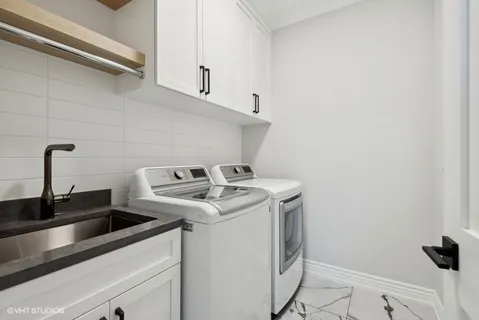 a view of storage and utility room with washer and dryer