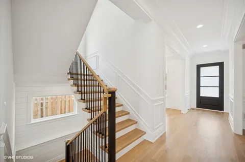 a view of entryway and hall with wooden floor