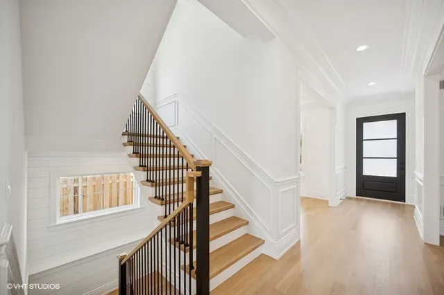 a view of entryway and hall with wooden floor