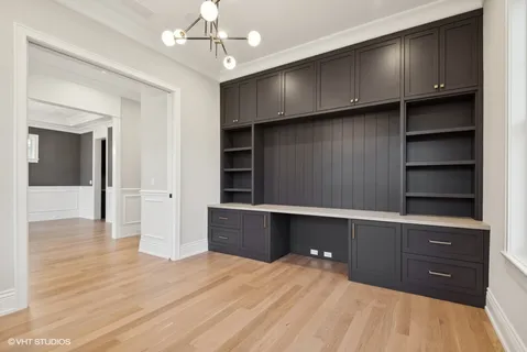 a room with kitchen island and cabinets