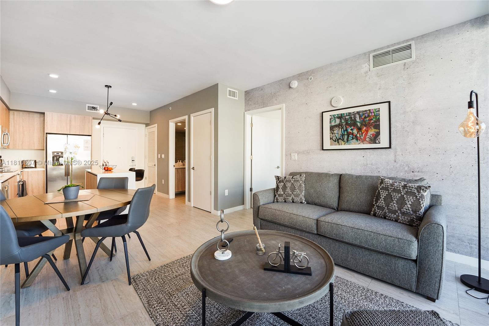 3900 Biscayne Boulevard, Unit S218 Miami, FL 33137 - Photo 2 of 36 a living room with furniture kitchen and a table