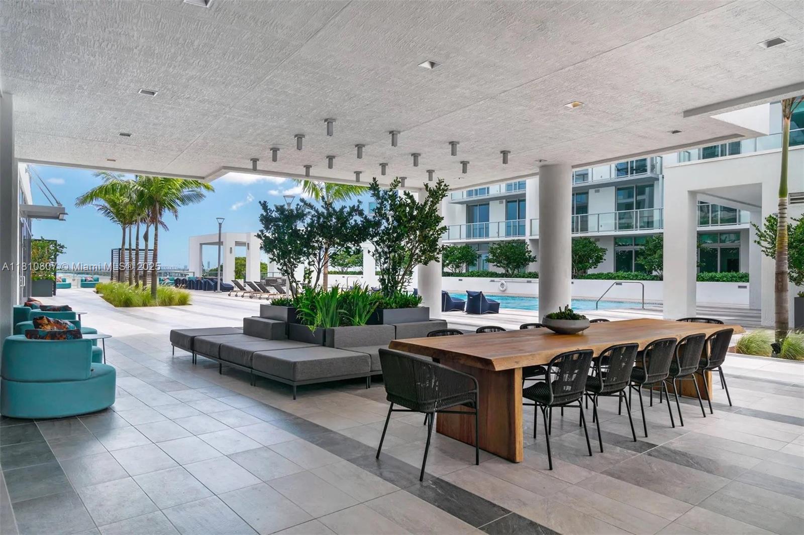 3900 Biscayne Boulevard, Unit S218 Miami, FL 33137 - Photo 21 of 36 a view of a patio with dining table and chairs