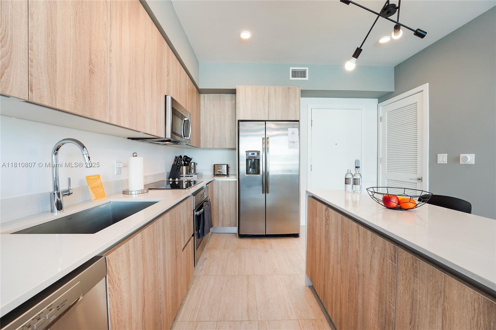 3900 Biscayne Boulevard, Unit S218 Miami, FL 33137 - Photo 4 of 36 a kitchen with stainless steel appliances a sink a refrigerator and a stove