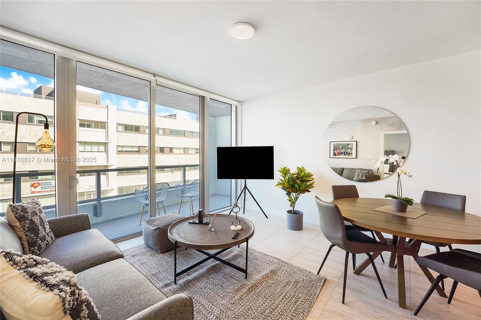 3900 Biscayne Boulevard, Unit S218 Miami, FL 33137 - Photo 5 of 36 a living room with furniture and a flat screen tv