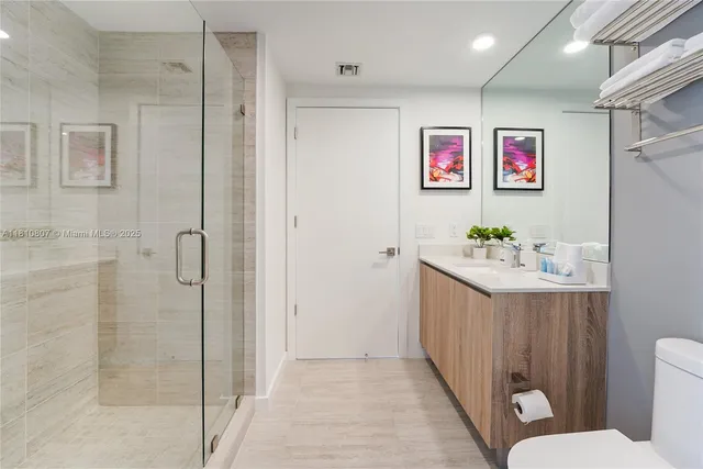 a bedroom with a large bed and a rug