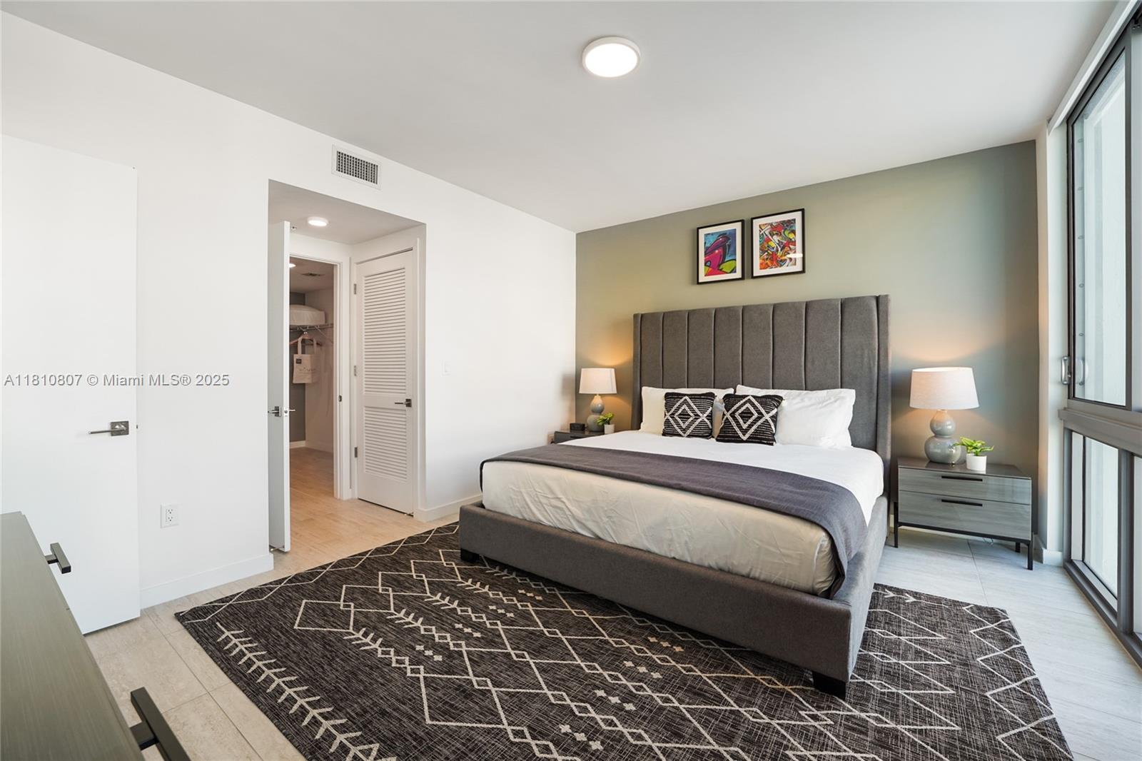 3900 Biscayne Boulevard, Unit S218 Miami, FL 33137 - Photo 8 of 36 a bedroom with a large bed and a rug