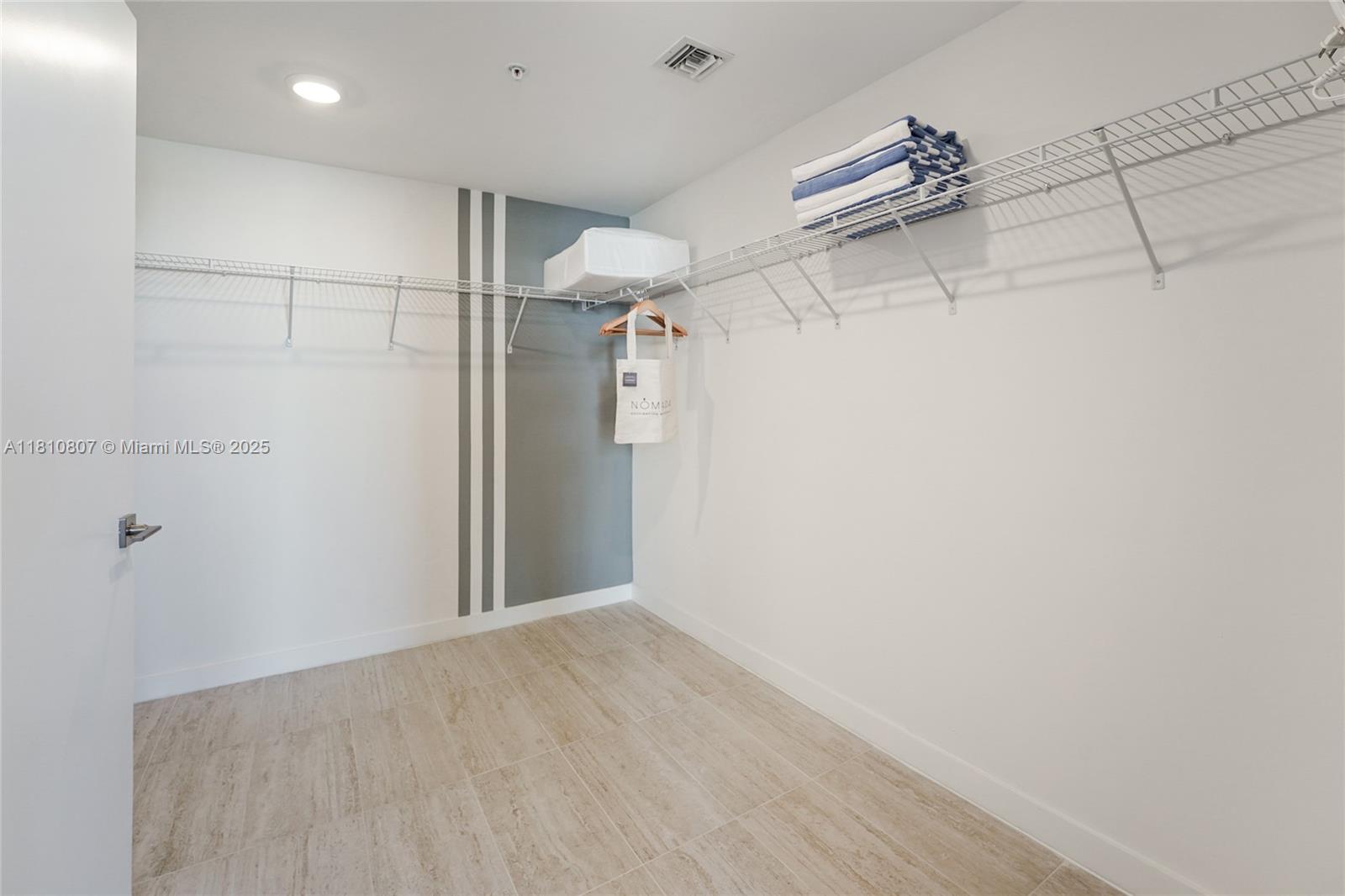 3900 Biscayne Boulevard, Unit S218 Miami, FL 33137 - Photo 9 of 36 a view of a room with racks on the wall