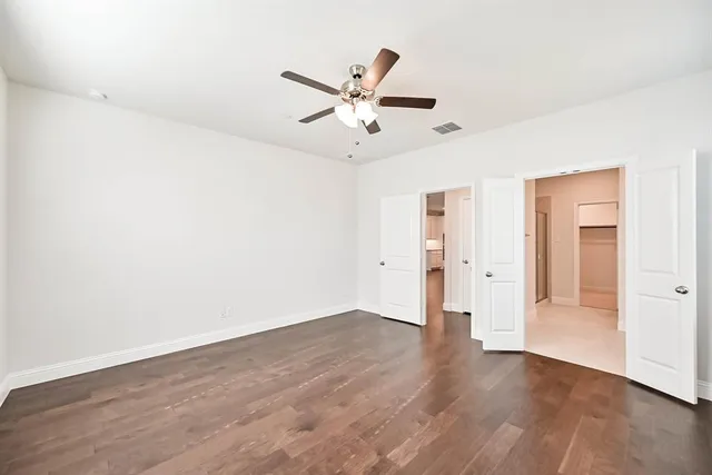 a kitchen with white cabinets and sink