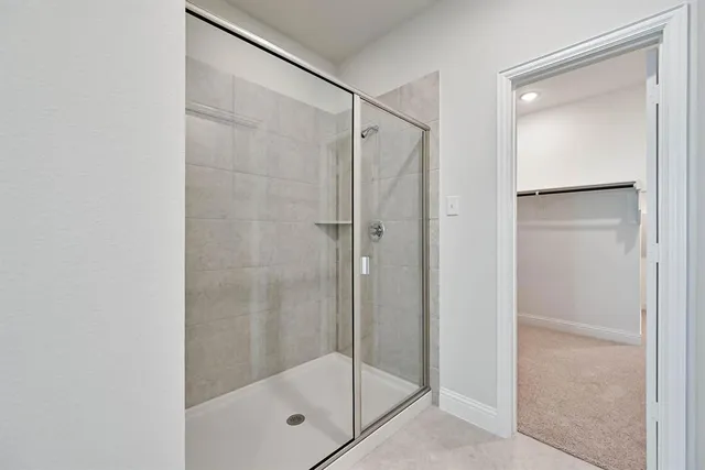 a bathroom with a glass shower door