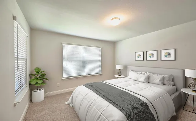 a bedroom with a large bed and a flat screen tv