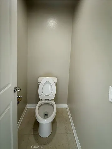 a white toilet sitting in a bathroom