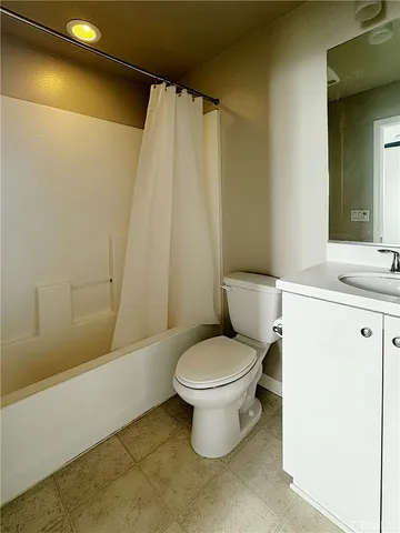 a white toilet sitting next to a bathroom sink and tub