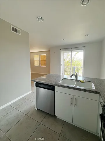a kitchen with granite countertop a sink and a stove