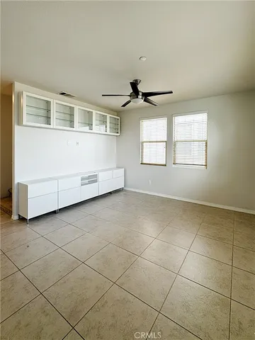 a view of a livingroom with an empty space and a window