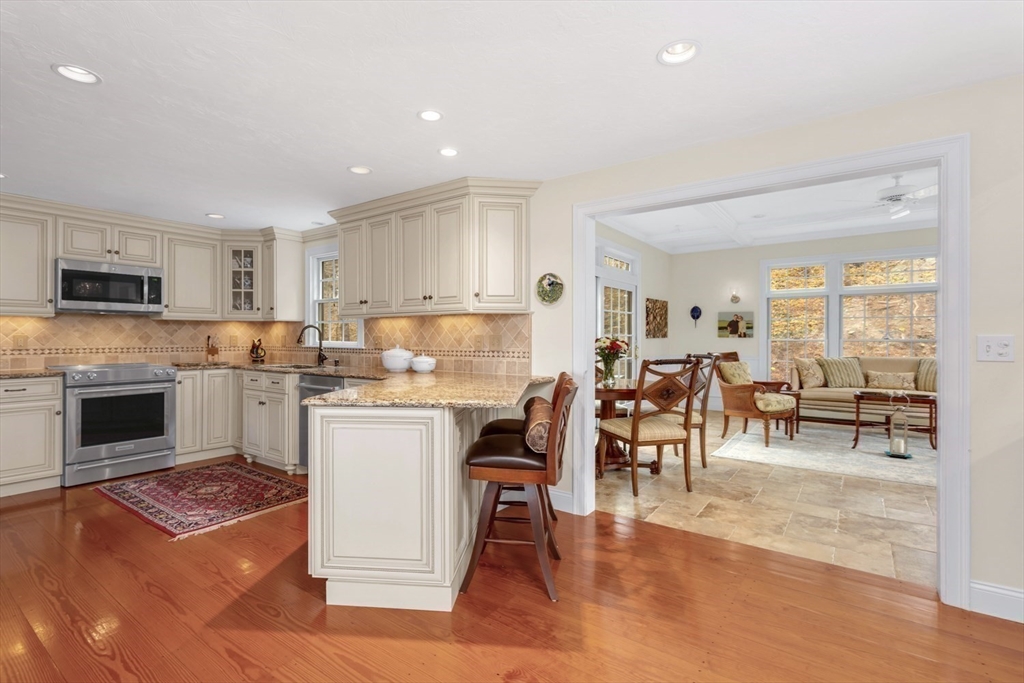 1 Delta Drive Franklin, MA 02038 - Photo 11 of 42 a living room with stainless steel appliances kitchen island granite countertop furniture and a fireplace