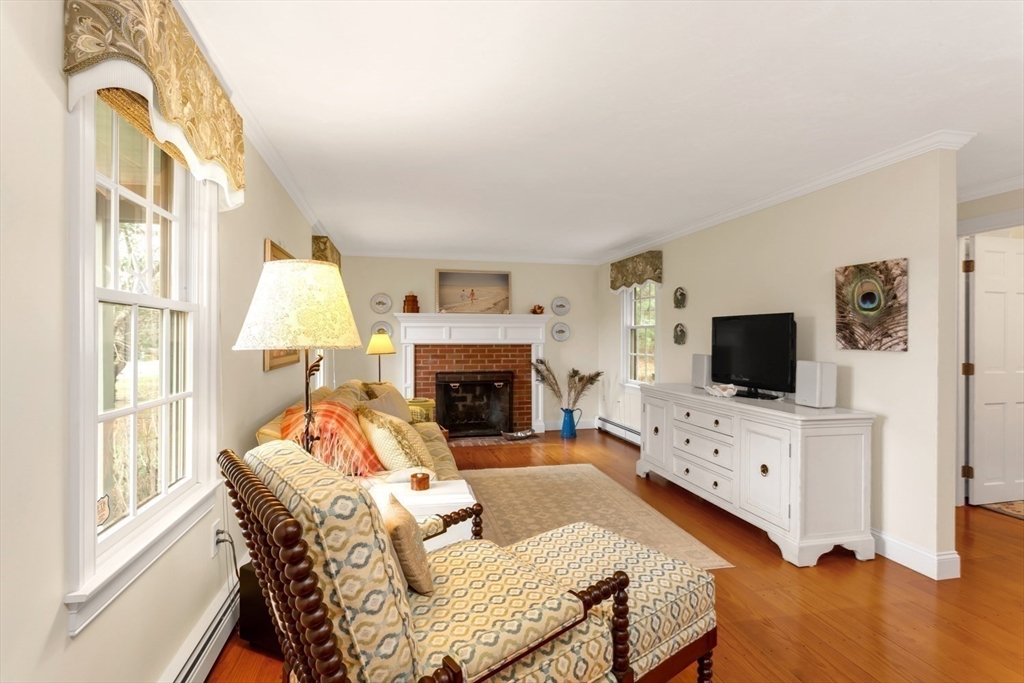 1 Delta Drive Franklin, MA 02038 - Photo 19 of 42 a living room with furniture a flat screen tv and a fireplace