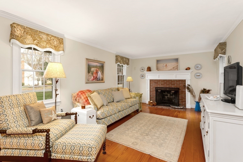 1 Delta Drive Franklin, MA 02038 - Photo 20 of 42 a living room with furniture a flat screen tv and a fireplace