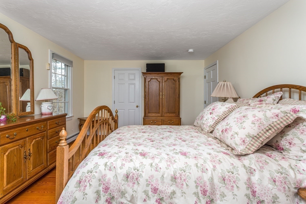 1 Delta Drive Franklin, MA 02038 - Photo 25 of 42 a bedroom with a large bed and wooden floor