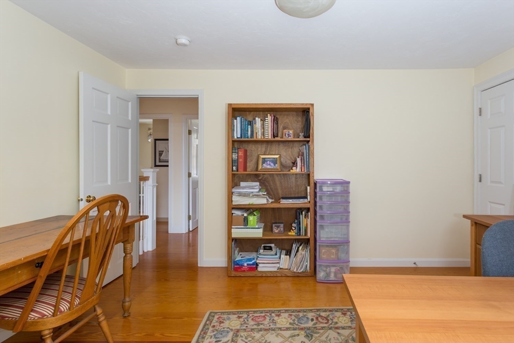 1 Delta Drive Franklin, MA 02038 - Photo 31 of 42 a living room with furniture a rug and a book shelf