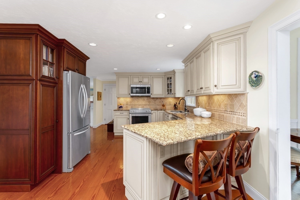 1 Delta Drive Franklin, MA 02038 - Photo 9 of 42 a kitchen with refrigerator cabinets and wooden floor