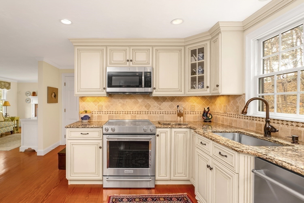 1 Delta Drive Franklin, MA 02038 - Photo 10 of 42 a kitchen with stainless steel appliances granite countertop a sink a stove a microwave and cabinets