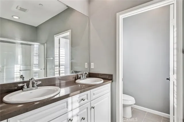a view of an empty room with wooden floor and closet