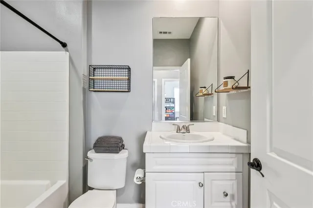 a view of a room with wooden floor and windows