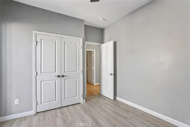 a view of a swimming pool with a table and chairs under an umbrella