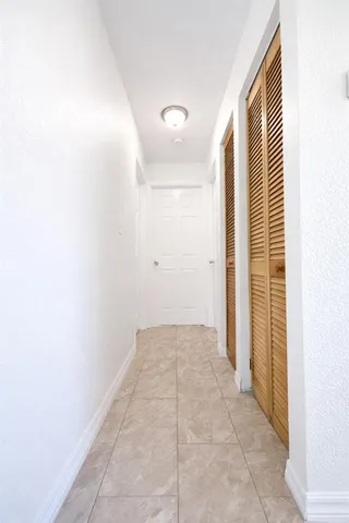 a view of a hallway to rooms