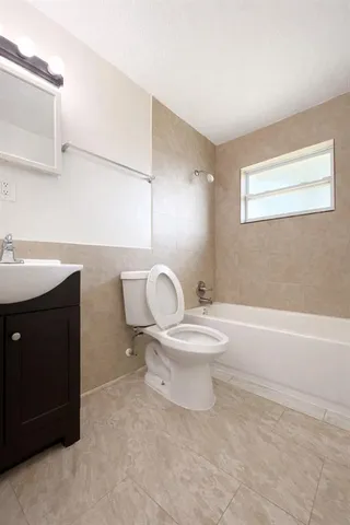 a bathroom with a toilet a sink and bathtub