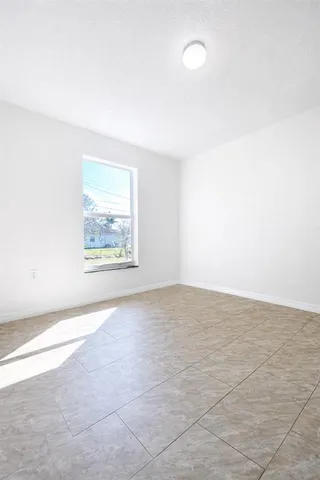 an empty room with a empty space and window