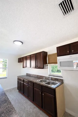 a kitchen with stainless steel appliances granite countertop a sink and a stove